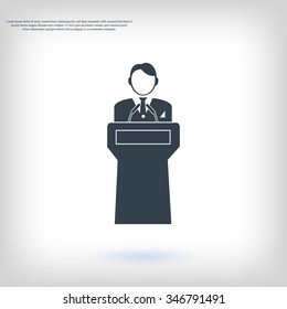  Speaker stands behind the podium