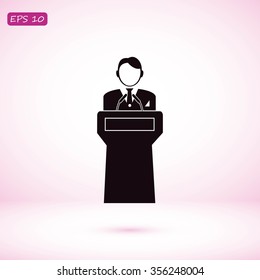  Speaker stands behind the podium