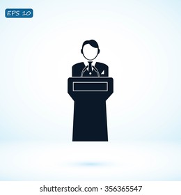  Speaker stands behind the podium
