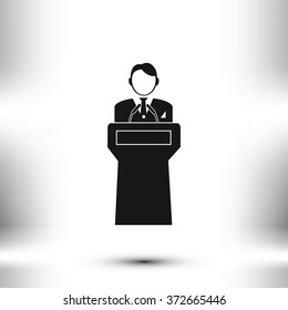  Speaker stands behind the podium
