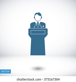  Speaker stands behind the podium