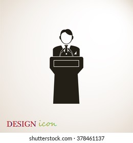  Speaker stands behind the podium