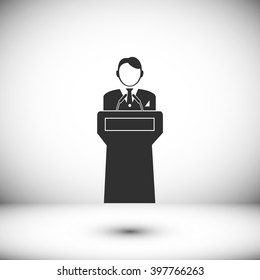  Speaker stands behind the podium
