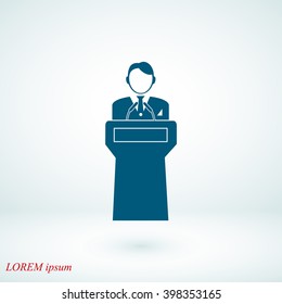  Speaker stands behind the podium