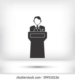  Speaker stands behind the podium