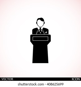  Speaker stands behind the podium