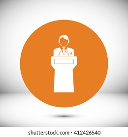  Speaker stands behind the podium