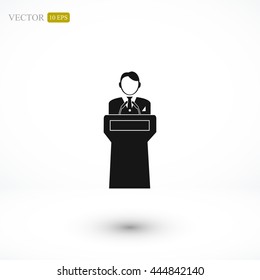  Speaker stands behind the podium