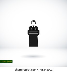  Speaker stands behind the podium