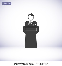  Speaker stands behind the podium