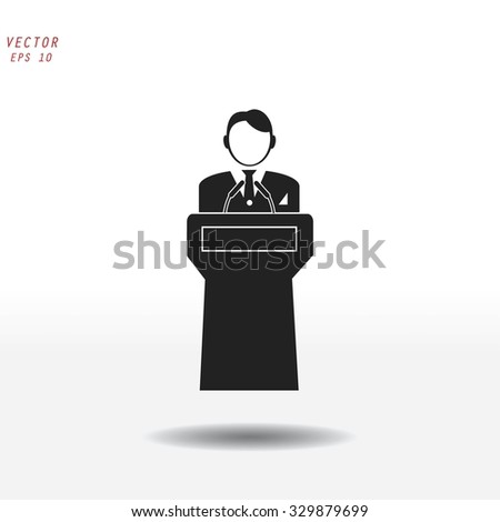  Speaker stands behind the podium