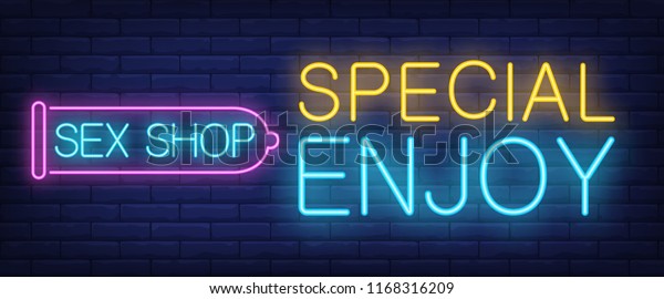 Special Enjoy Neon Sign Glowing Sex Shop Lettering In Condom Outline On Brick Background Night