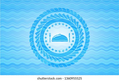 special food icon inside light blue water wave style badge.
