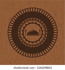 special food icon inside wooden emblem