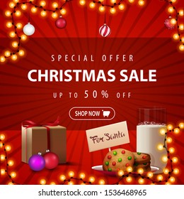 Special offer, Christmas sale, up to 50% off, square red discount banner with garland, Christmas balls, present and cookies with a glass of milk for Santa Claus