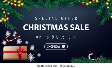 Special offer, Christmas sale, up to 50% off, blue discount banner with garland, Christmas tree, present, paper snowflakes and candy can, top view
