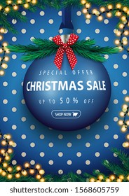 Special offer, Christmas sale, up to 50% off, blue vertical discount banner with big blue Christmas ball with offer. Garland, polka dot texture, christmas tree and red bow