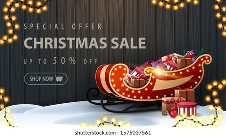 Special offer, Christmas sale, up to 50% off, discount banner with wooden fence of boards with frame of Christmas tree branches, garland of yellow bulb lights and Santa Sleigh with presents