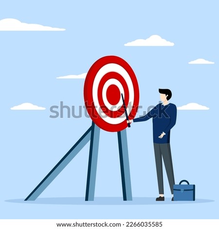 Specific aim concept, perfection or target target concept, aim or target clarification, focus or concentration on aim to win business mission, businessman pointing to bullseye archery target center.