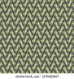 Speckled pieces, in the shape of a parallelogram, arranged in a zigzag pattern. Repeated decorative design in black and light green.