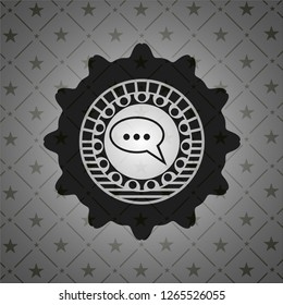 speech bubble icon inside black emblem