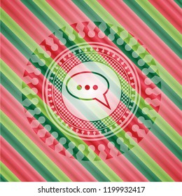 speech bubble icon inside christmas emblem.