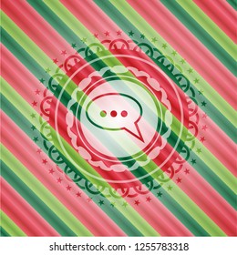 speech bubble icon inside christmas colors emblem.