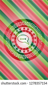 speech bubble icon inside christmas colors emblem.