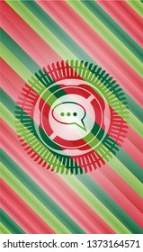 speech bubble icon inside christmas colors badge.
