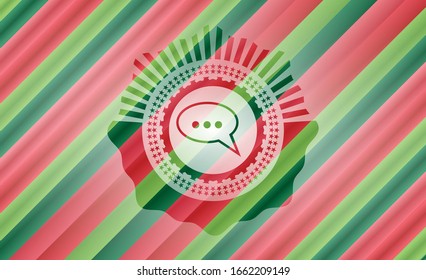 speech bubble icon inside christmas colors style badge.