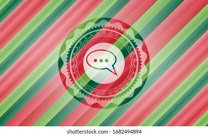 speech bubble icon inside christmas colors style badge.