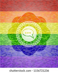 speech bubble icon inside emblem on mosaic background with the colors of the LGBT flag