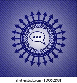 speech bubble icon inside emblem with jean background