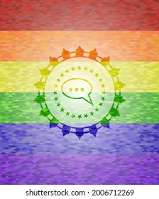 speech bubble icon inside emblem on mosaic background with the colors of the LGBT flag. 