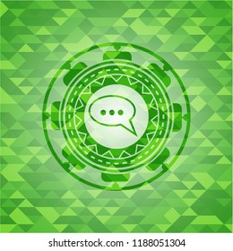 speech bubble icon inside green emblem with mosaic ecological style background