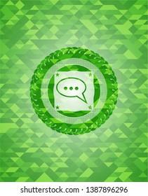 speech bubble icon inside green mosaic emblem