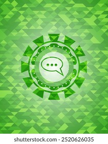 speech bubble icon inside green emblem with triangle mosaic background. 