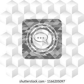 speech bubble icon inside grey icon or emblem with geometric cube white background