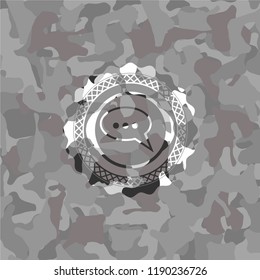 speech bubble icon inside grey camouflage texture