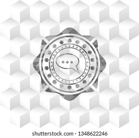 speech bubble icon inside grey icon or emblem with geometric cube white background