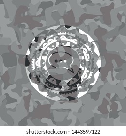 speech bubble icon inside grey camouflage texture