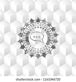 speech bubble icon inside realistic grey emblem with geometric cube white background