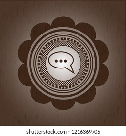 speech bubble icon inside retro style wood emblem