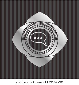 speech bubble icon inside silvery emblem