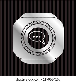 speech bubble icon inside silvery emblem