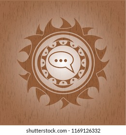 speech bubble icon inside vintage wood emblem