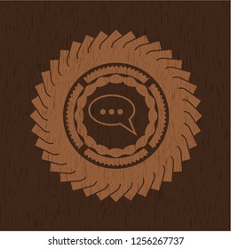 speech bubble icon inside vintage wooden emblem