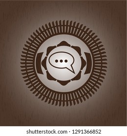 speech bubble icon inside vintage wood emblem