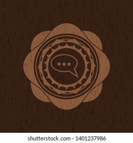 speech bubble icon inside wood emblem