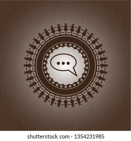 speech bubble icon inside wooden emblem. Vintage.